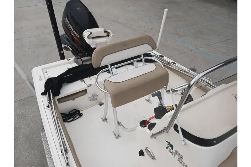 Slide: The Image of 2015 Key West 210 Bay Reef boat interior with seating and motor. - 10