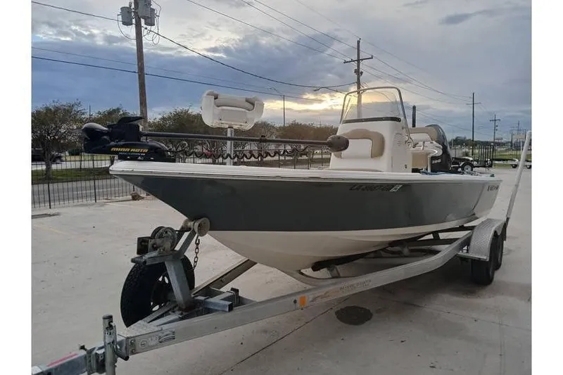 Slide: The Image of 2015 Key West 210 Bay Reef boat on trailer, parked outdoors under cloudy sky. - 3