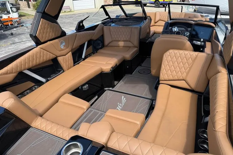Slide: The Image of Luxurious interior of 2026 Tigé Z3 boat with tan leather seating and modern dashboard. - 10