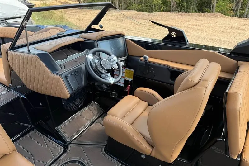 Slide: The Image of 2026 Tigé Z3 boat interior with tan leather seats and modern dashboard. - 11