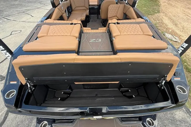 Slide: The Image of 2026 Tigé Z3 boat interior with tan leather seating and open storage compartment. - 17