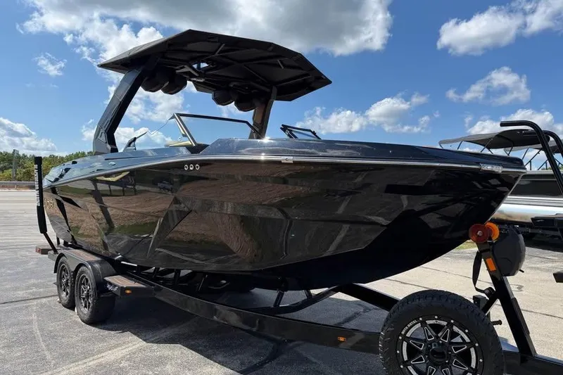 Slide: The Image of 2026 Tigé Z3 boat on trailer under blue sky. - 3