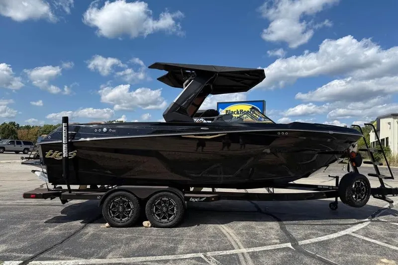 Slide: The Image of 2026 Tigé Z3 boat on trailer under blue sky with clouds. - 4