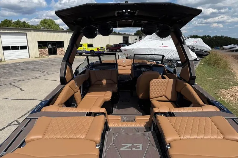 Slide: The Image of 2026 Tigé Z3 boat with luxurious tan seating and modern design at a marina. - 8