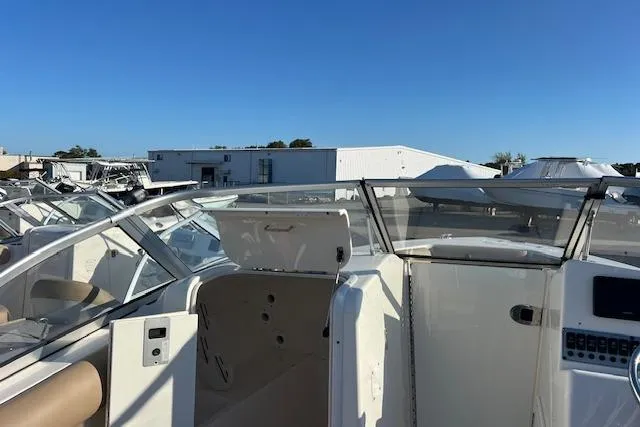Slide: The Image of 2019 Key West 239 DFS boat with open cockpit, docked under clear blue sky. - 6