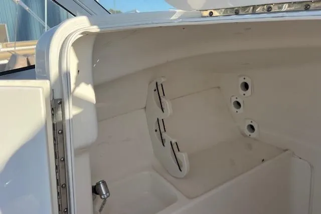 Slide: The Image of 2019 Key West 239 DFS boat interior storage compartment with rod holders. - 8
