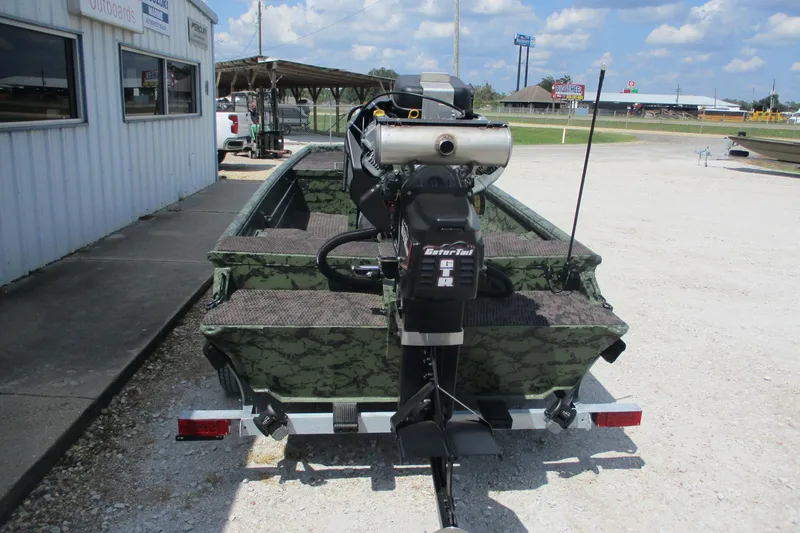 Slide: The Image of 2026 Gator Tail 1860 Extreme CC boat with camouflage design and powerful outboard motor. - 2