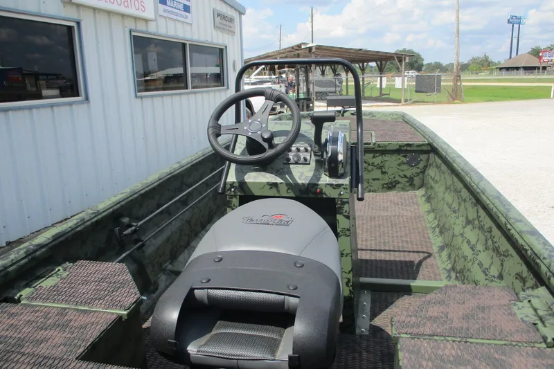Slide: The Image of 2026 Gator Tail 1860 Extreme CC boat interior with steering wheel and camouflage design. - 6