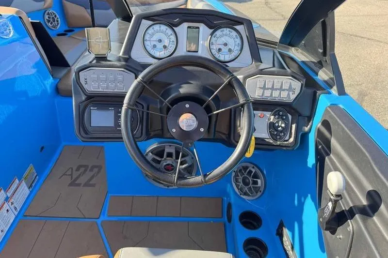 Slide: The Image of 2021 Axis A22 boat dashboard with steering wheel and control panel. - 12