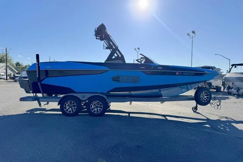 Slide: The Image of 2021 Axis A22 boat on trailer under bright sunlight in parking lot. - 4