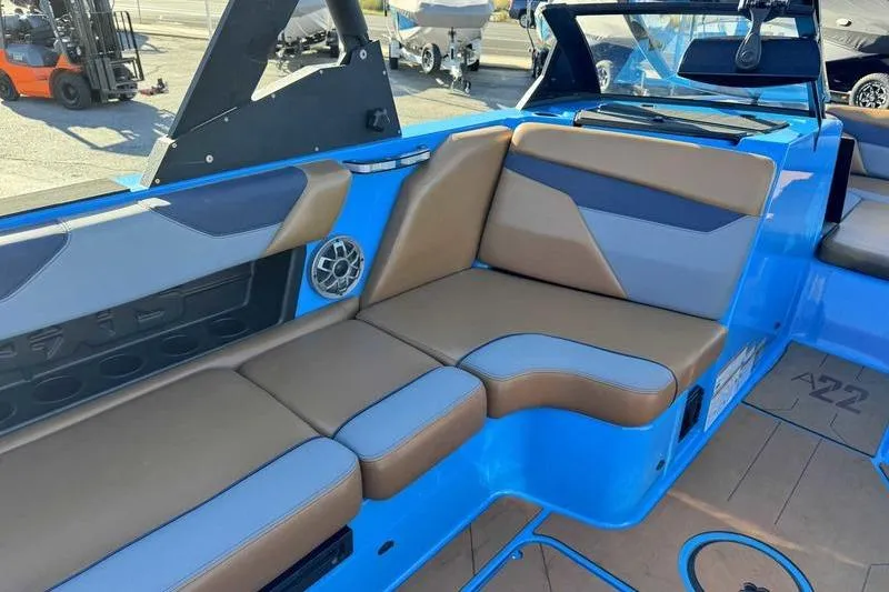 Slide: The Image of 2021 Axis A22 boat interior with blue and tan seating, speaker, and modern design. - 7