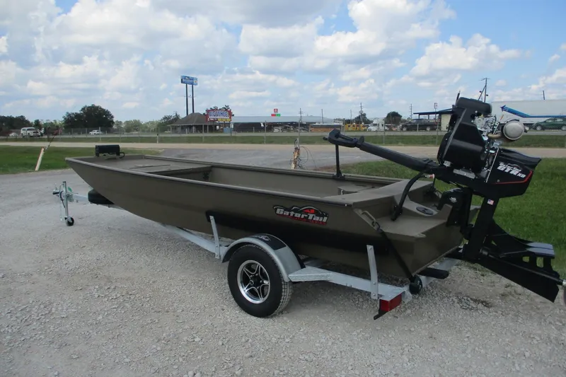 Slide: The Image of 2026 Gator Tail 1748 GATOR boat on trailer, parked outdoors under cloudy sky. - 1