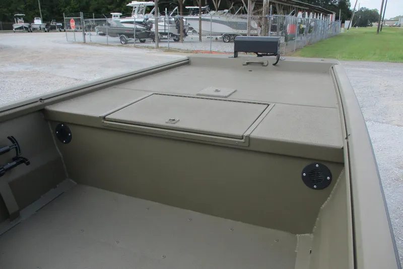 Slide: The Image of 2026 Gator Tail 1748 GATOR boat interior with storage compartment, parked near other boats. - 7