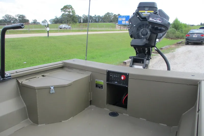 Slide: The Image of 2026 Gator Tail 1748 GATOR boat with motor, parked near a grassy roadside. - 9