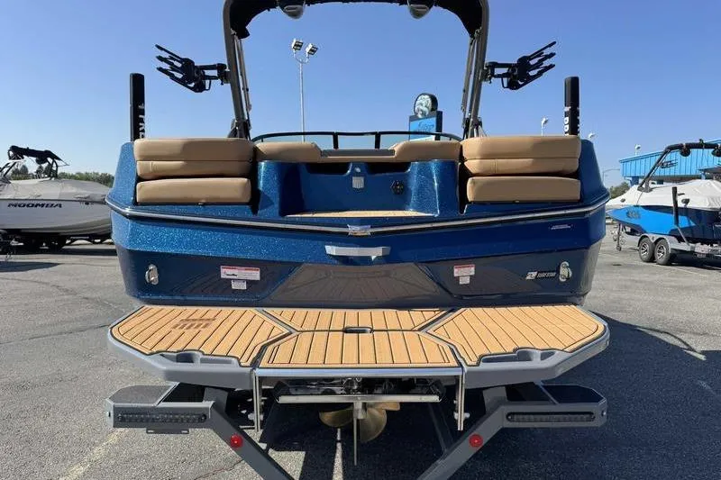 Slide: The Image of 2026 MasterCraft XT22 boat, rear view with teak swim platform and seating. - 12