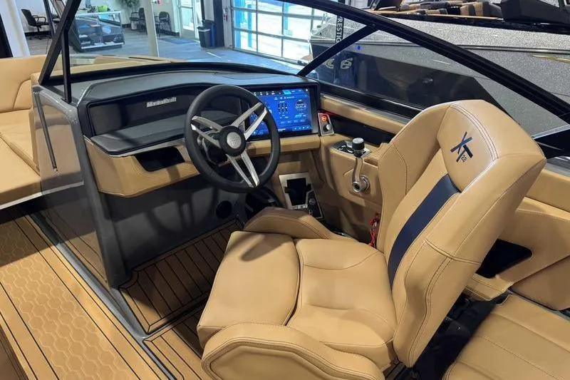 Slide: The Image of 2026 MasterCraft XT22 boat interior with modern dashboard and tan seating. - 5