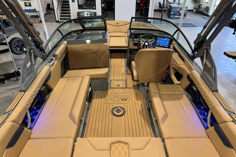 Slide: The Image of 2026 MasterCraft XT22 boat interior with tan seating and modern dashboard. - 9