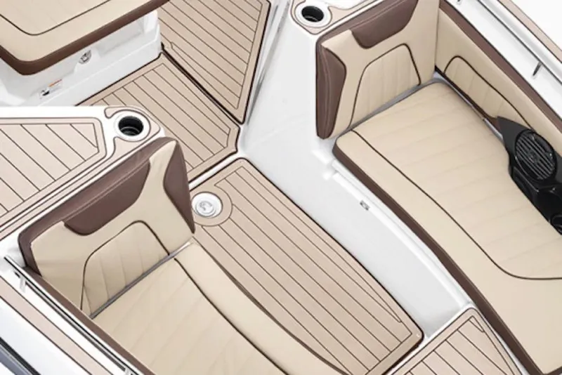 Slide: The Image of 2026 Yamaha Boats 255 FSH Sport E interior with beige and brown seating and flooring. - 3