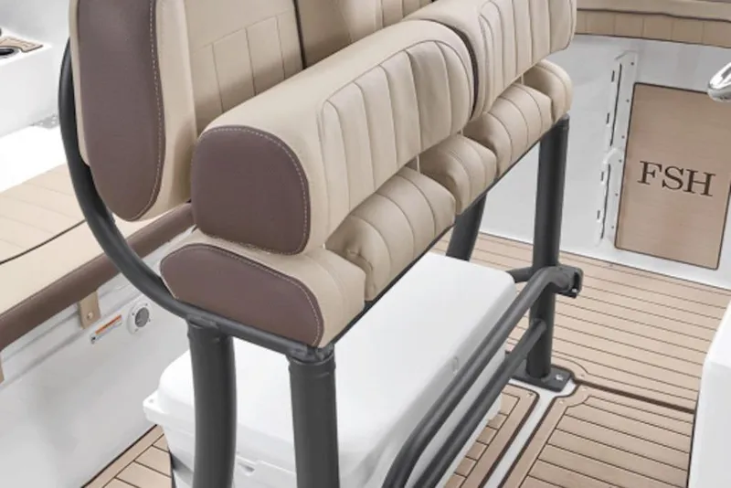 Slide: The Image of 2026 Yamaha Boats 255 FSH Sport E interior seating with beige and brown upholstery. - 4