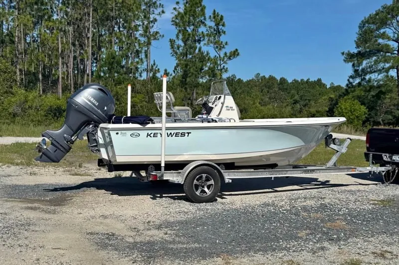 The Image of 2021 Key West 188 Bay Reef boat on trailer, parked outdoors near trees. - 0
