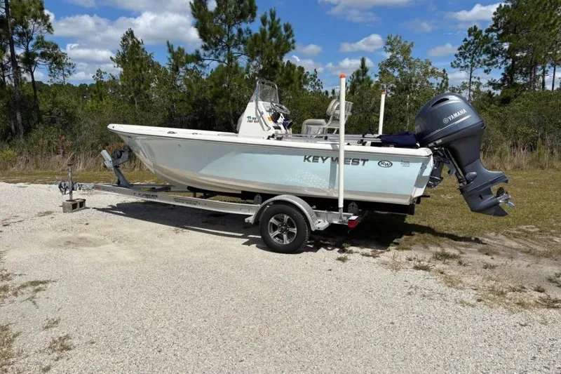 Slide: The Image of 2021 Key West 188 Bay Reef boat on trailer, parked outdoors. - 2