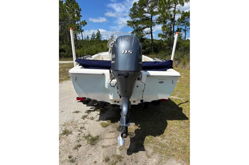 Slide: The Image of 2021 Key West 188 Bay Reef boat with Yamaha 115 outboard motor, parked outdoors. - 9