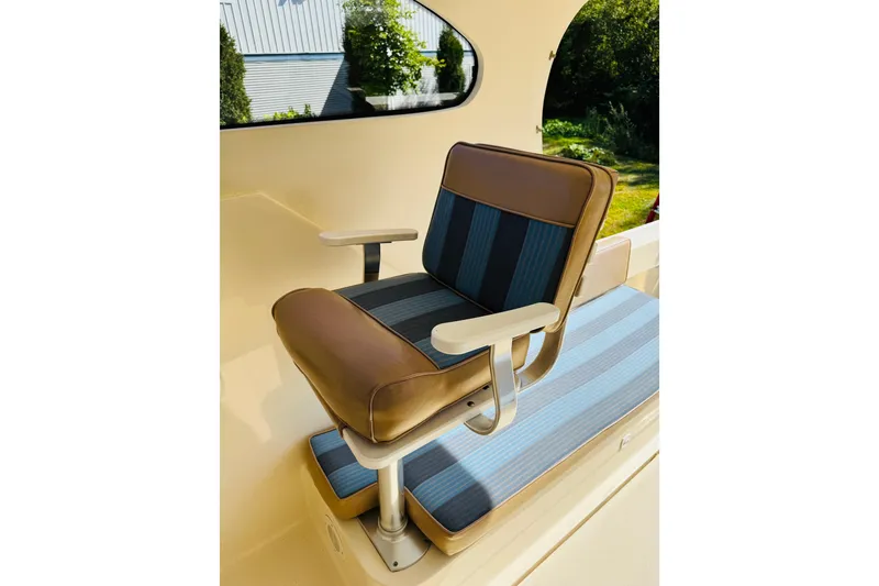 Slide: The Image of 2006 Mainship Pilot 30 Sedan interior with cushioned seating and armrests. - 15