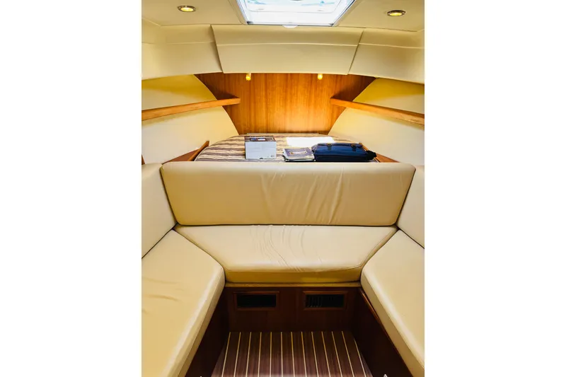 Slide: The Image of 2006 Mainship Pilot 30 Sedan interior with beige seating and wood accents. - 2