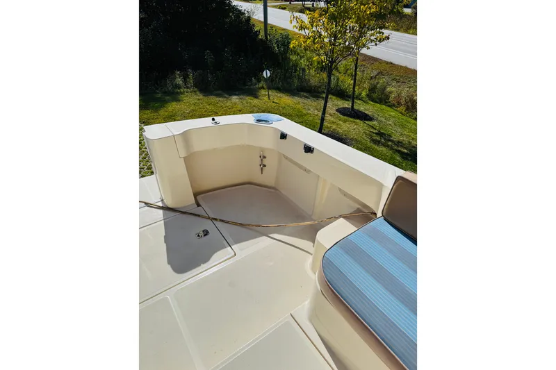 Slide: The Image of 2006 Mainship Pilot 30 Sedan boat deck with seating and storage area. - 21