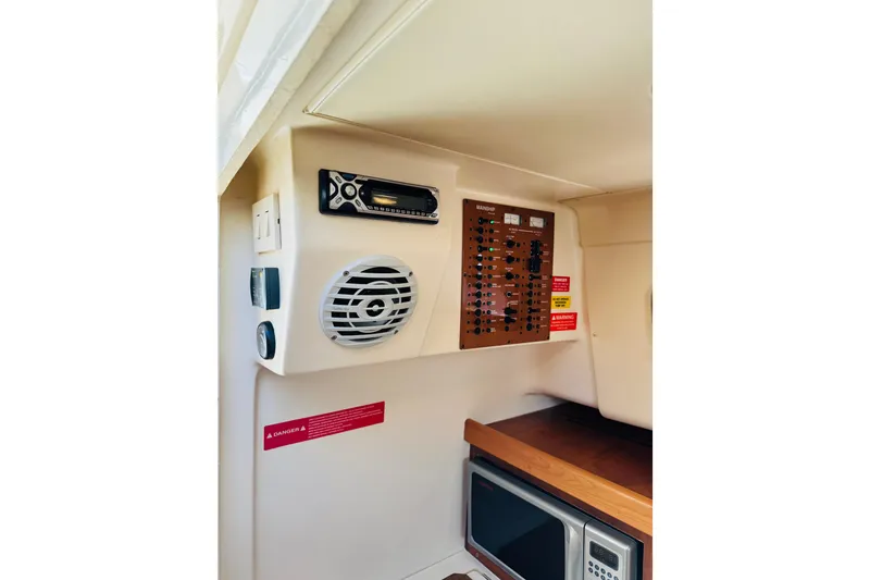 Slide: The Image of 2006 Mainship Pilot 30 Sedan interior with control panel and speaker system. - 23