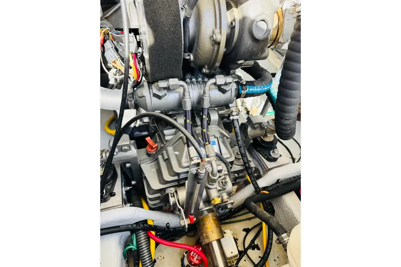 Slide: The Image of Engine compartment of a 2006 Mainship Pilot 30 Sedan boat, showcasing mechanical components. - 25