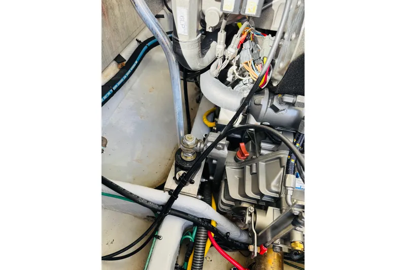 Slide: The Image of Engine compartment of a 2006 Mainship Pilot 30 Sedan with visible wiring and components. - 27