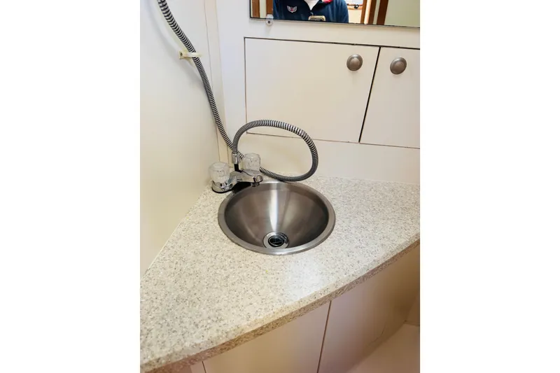 Slide: The Image of Compact sink area in 2006 Mainship Pilot 30 Sedan boat interior. - 8