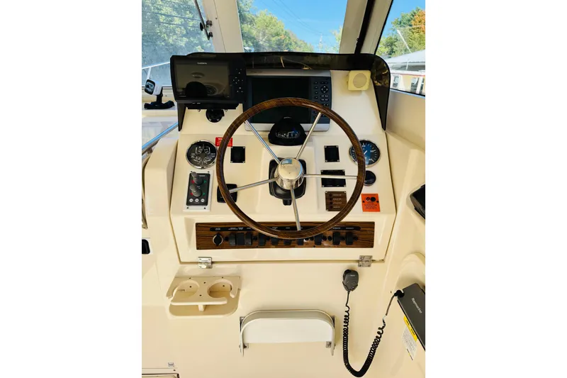 Slide: The Image of 2006 Mainship Pilot 30 Sedan helm with steering wheel and navigation controls. - 9
