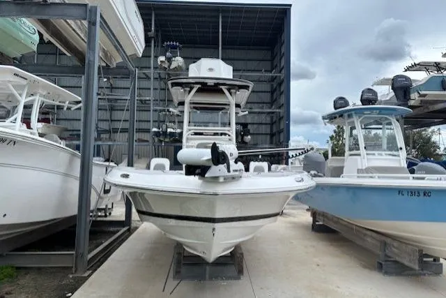 Slide: The Image of 2023 Caymas 26 HB boat in storage, front view, surrounded by other boats. - 10