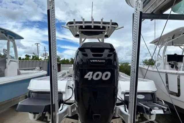 Slide: The Image of 2023 Caymas 26 HB boat with powerful Verado 400 engine, docked under cloudy sky. - 11