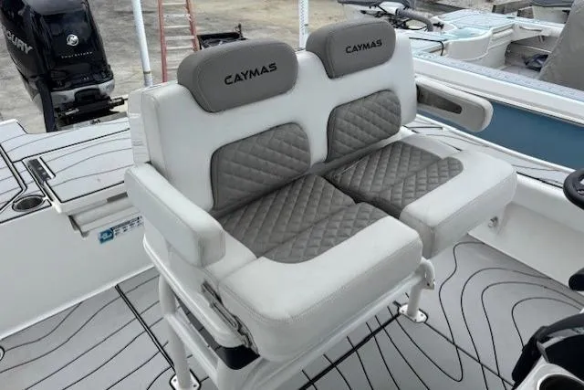 Slide: The Image of 2023 Caymas 26 HB boat interior with cushioned seating and modern design. - 16