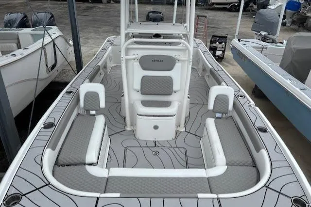 Slide: The Image of 2023 Caymas 26 HB boat interior with gray seating and modern design. - 18