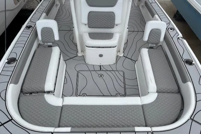 Slide: The Image of 2023 Caymas 26 HB boat interior with gray cushioned seating and stylish deck design. - 19