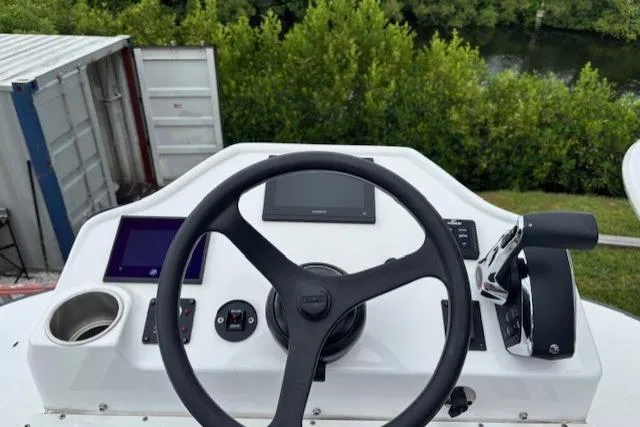 Slide: The Image of 2023 Caymas 26 HB boat helm with steering wheel and control panel. - 20