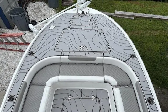 Slide: The Image of 2023 Caymas 26 HB boat deck with sleek, modern design and storage compartments. - 21