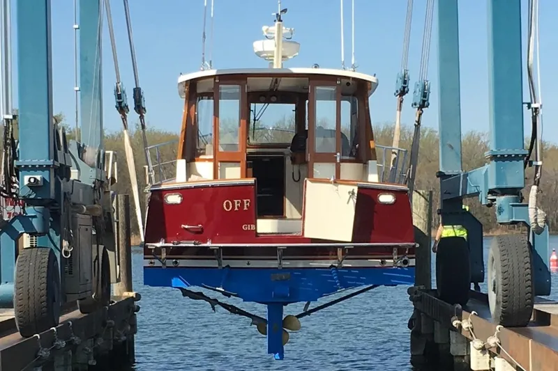 Slide: The Image of 2007 Legacy Yachts 32 being lifted from water by boat hoist. - 13