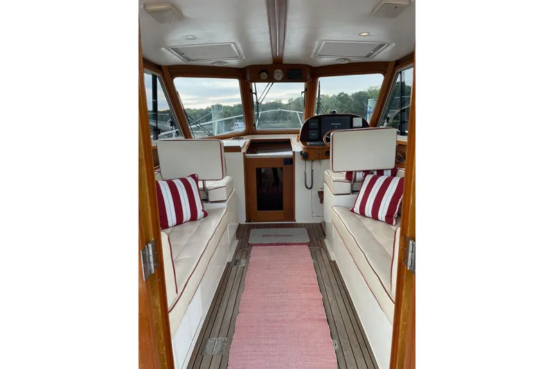 Slide: The Image of Interior of 2007 Legacy Yachts 32 with striped cushions and wooden accents. - 19
