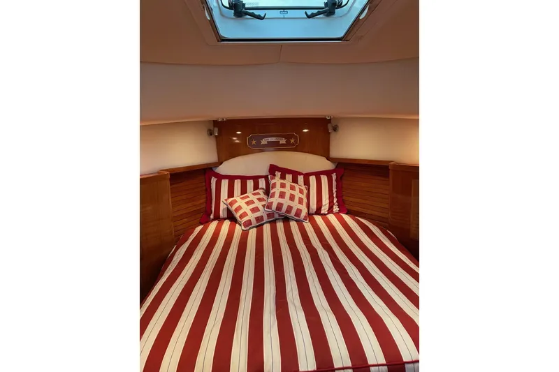 Slide: The Image of Cozy cabin interior of 2007 Legacy Yachts 32 with striped bedding and skylight. - 20