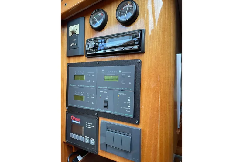 Slide: The Image of Control panel of a 2007 Legacy Yachts 32, featuring gauges and electronic systems. - 25
