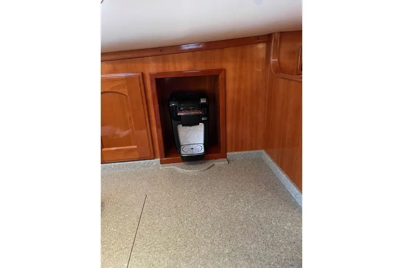 Slide: The Image of 2007 Legacy Yachts 32 interior with built-in coffee maker and wooden cabinetry. - 29