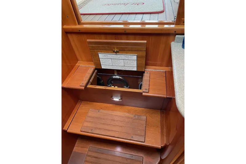 Slide: The Image of Interior view of 2007 Legacy Yachts 32, showcasing wooden steps and storage compartment. - 30