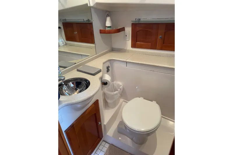 Slide: The Image of 2007 Legacy Yachts 32 bathroom with sink, toilet, and wooden cabinetry. - 31