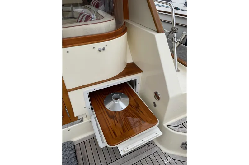 Slide: The Image of 2007 Legacy Yachts 32, wooden deck detail with storage compartment open. - 35