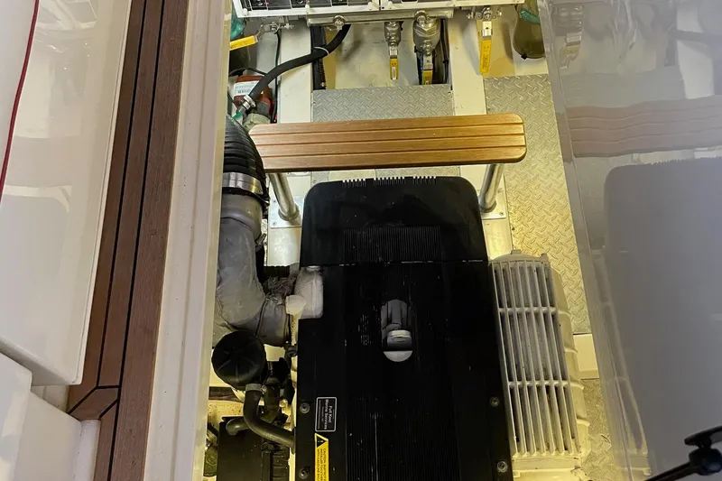 Slide: The Image of Engine compartment of a 2007 Legacy Yachts 32, showcasing mechanical components and wooden accents. - 36